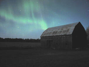 Northern Lights over a barn